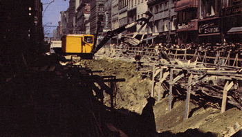 Initial stages of construction on Canada's First Subway. Excavation and supporting utilities, Yonge Street south of Adelaide Street.