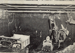 Tunnel excavation under temporary roof decking on downtown section of subway