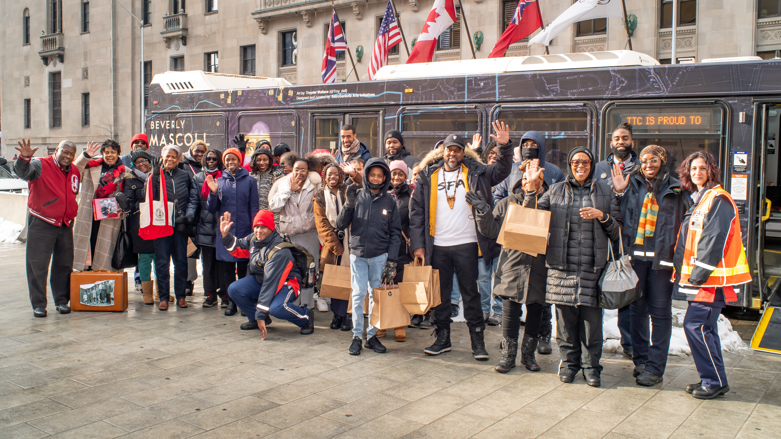 People in front of wrapped bus