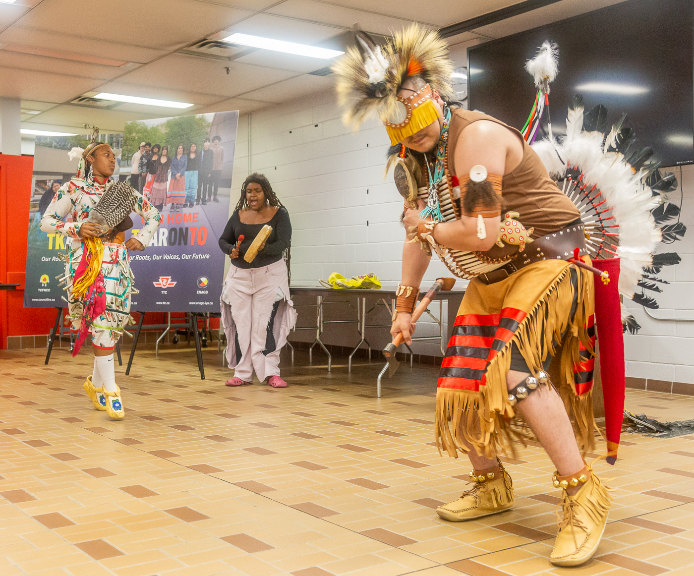 Indigenous dancers wearing traditional regalia perform during a TTC Every Child Matters event.