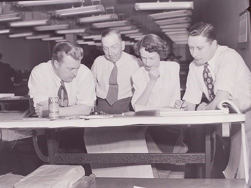 City of Toronto Archives/TTC Series 2166, File 78, Item 4. D. Souter, C. Rock, Louise Arnott, C. Calderbank examining plans, November 1944