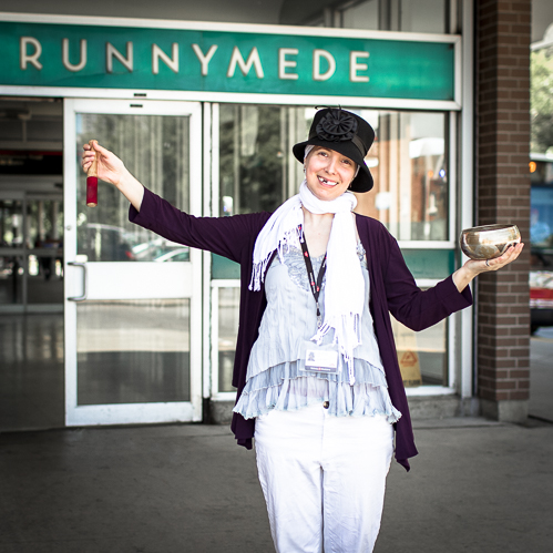 Chagall Sierra stands expressively in-front of the entrance to a subway station.