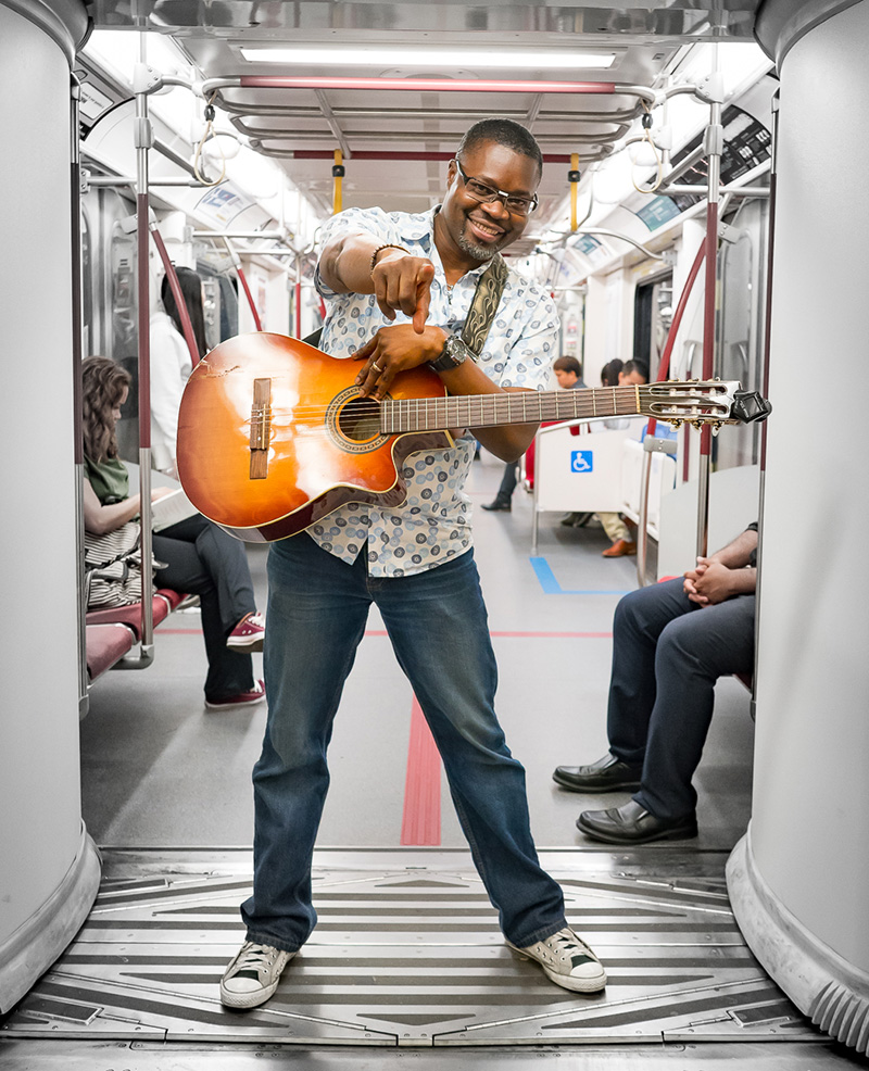 Dieufaite Charles on subway car holding guitar