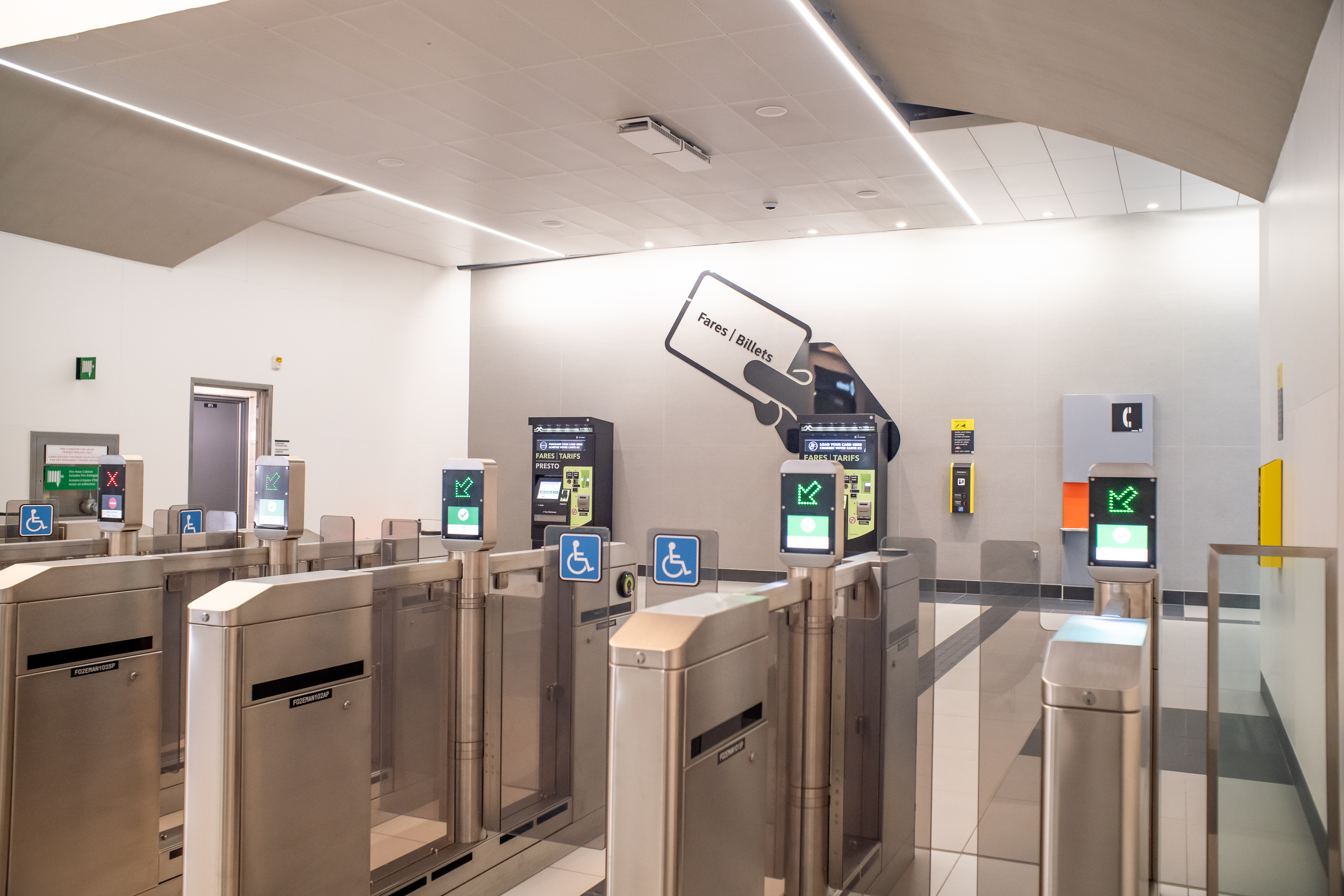 Silver fare gates at a TTC station with PRESTO machines in the background.