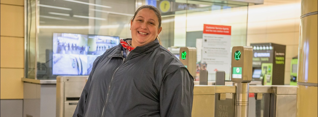 TTC employee in front of fare gates
