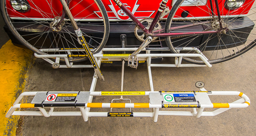 Labels on a restricted bicycle rack on a bus.
