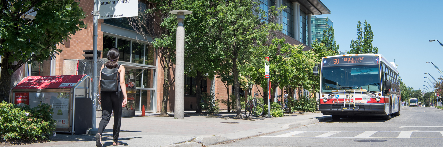 a girl walking on the street, TTC bus 60 passing by