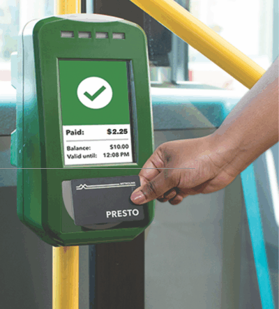 Person tapping a PRESTO card on a card reader