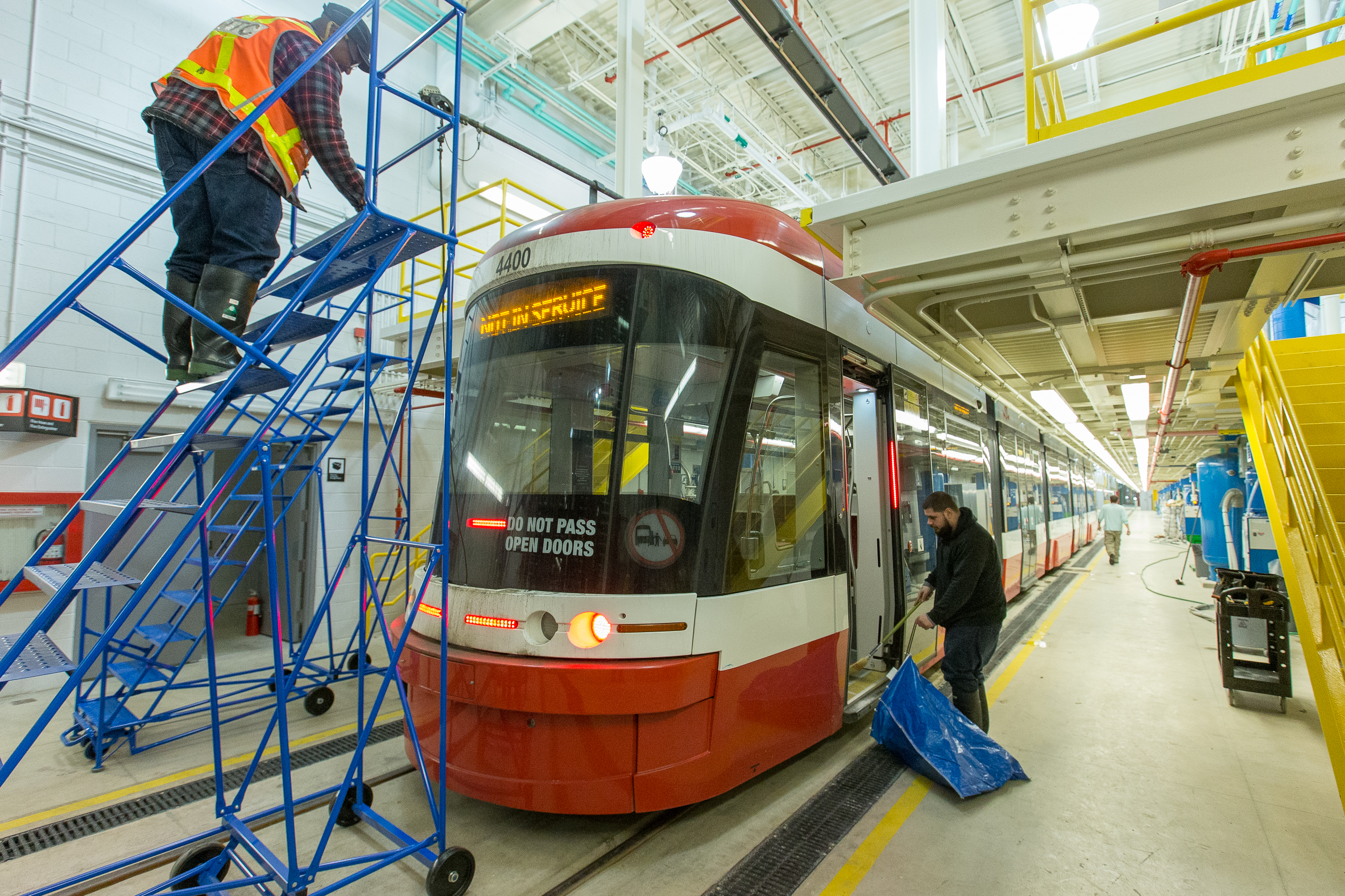 TTC employees perform maintenance on a streetcar at Hillcrest Complex.