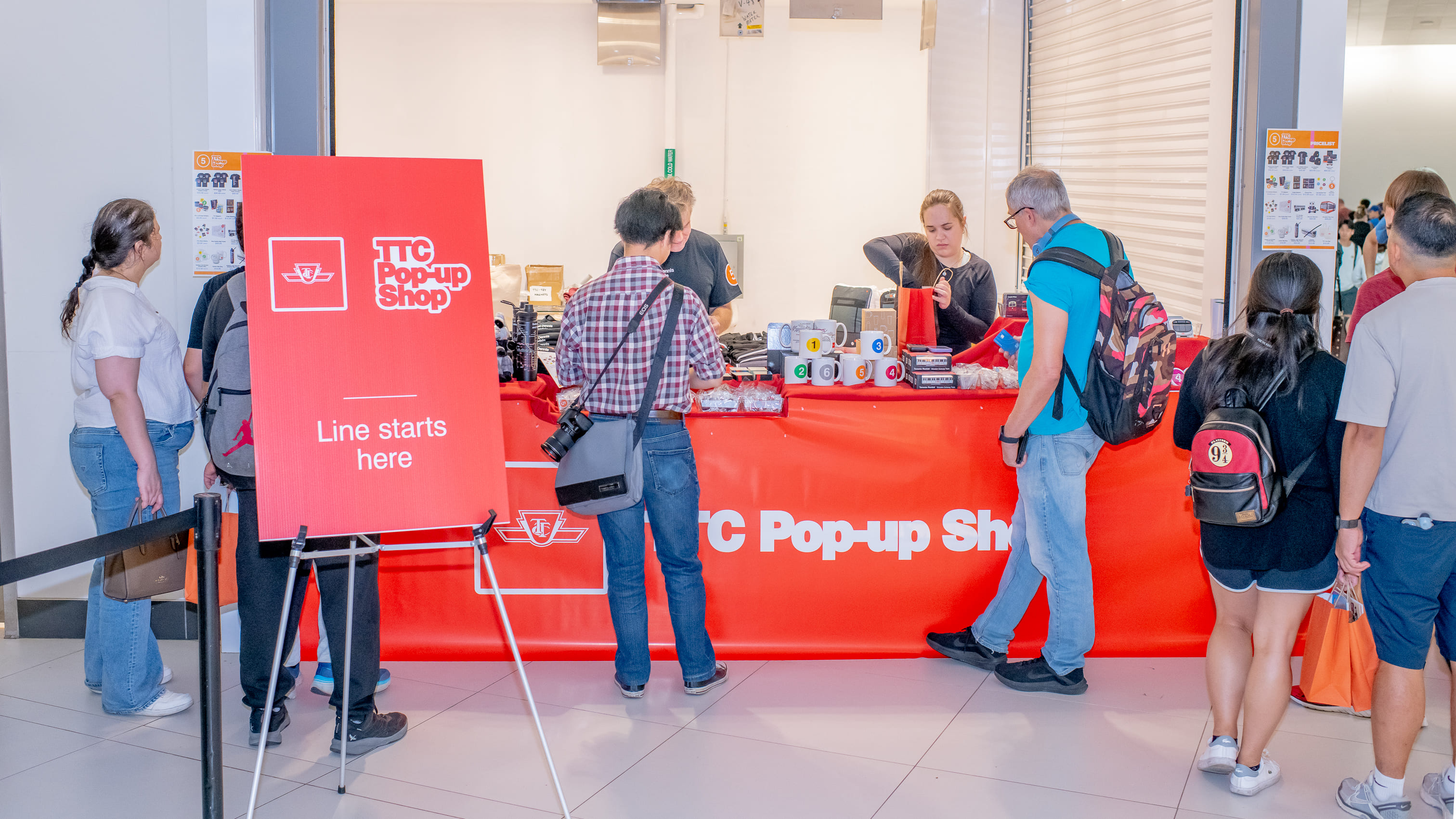 Visitors browsing merchandise at the TTC Pop-Up Shop, at the Line 5 Eglinton Celebration