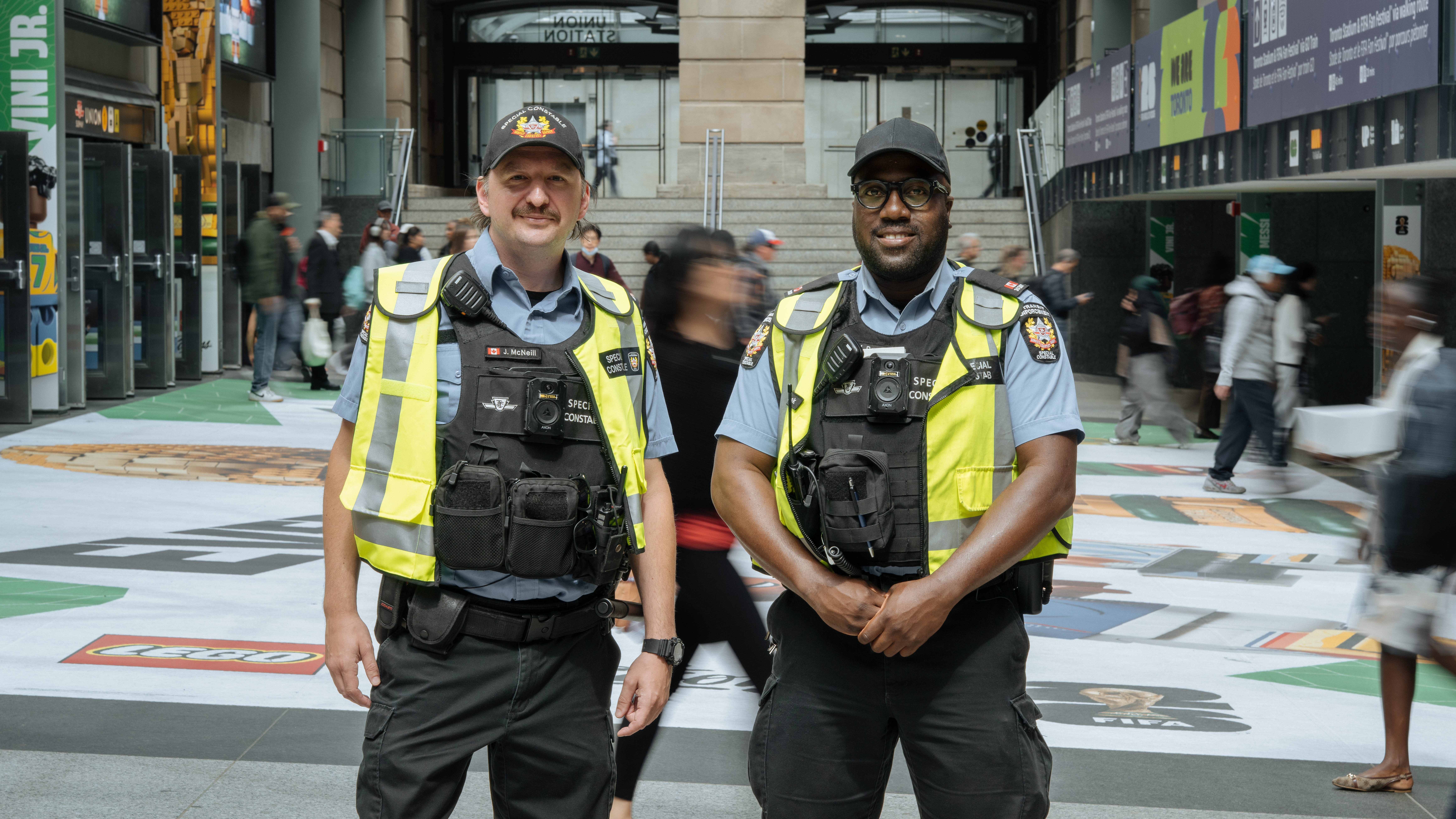 TTC Special Constables standing in a busy subway station.