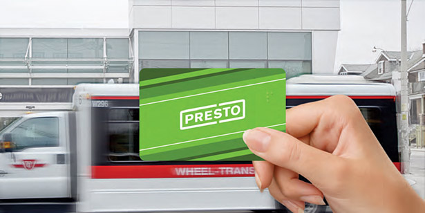 A hand holds a PRESTO card.  A Wheel-Trans vehicle is in the background.