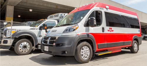 New TTC Wheel Trans Mini-bus standing next to older model Wheel Trans vehicle