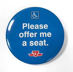 Blue button with TTC logo and reading Please offer me a seat