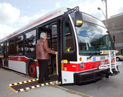 a customer using an accessibility ramp on a TTC bus.