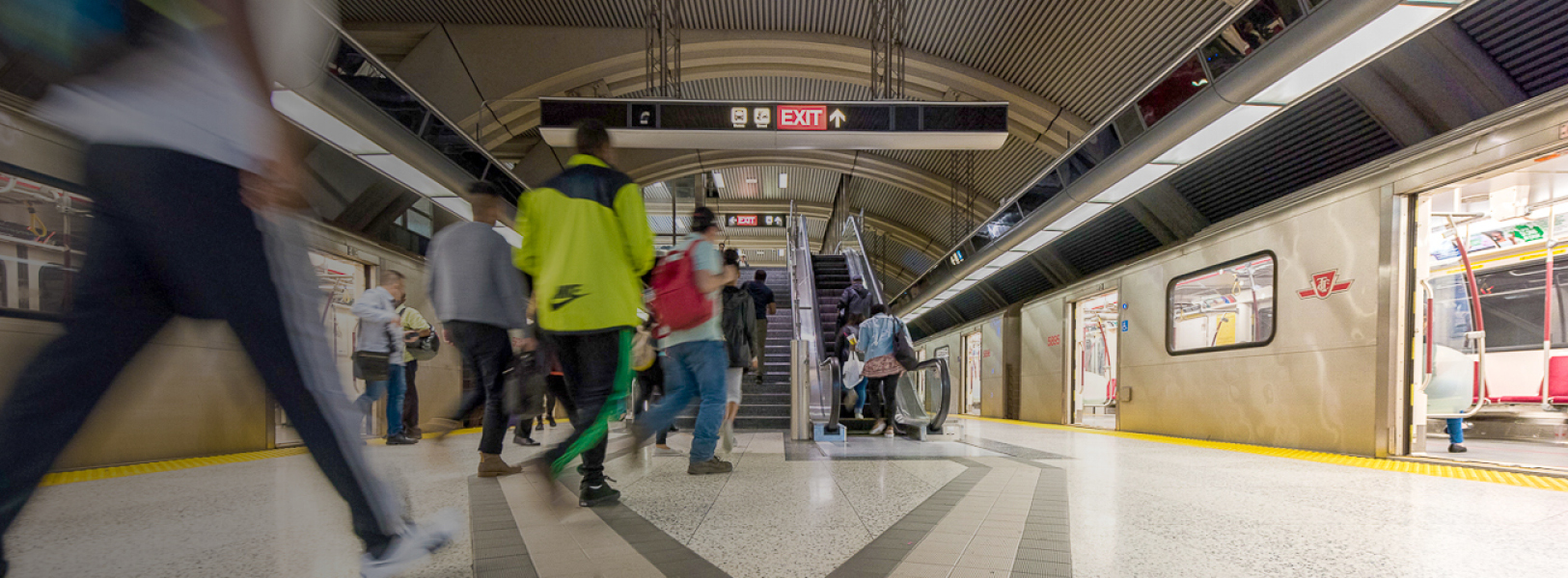 Image of customers on a subway platform, train in the background