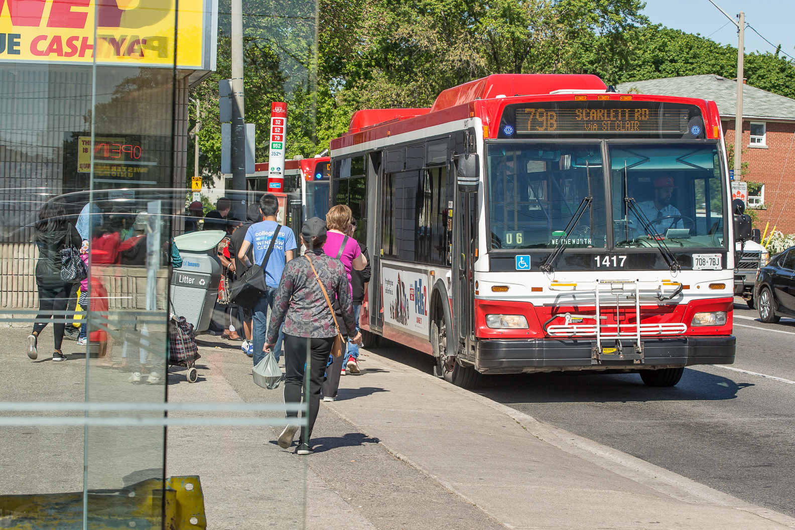 Customers boarding bus on street