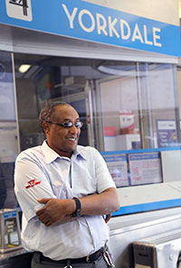 TTC Collector smiles infront of a TTC collection booth.